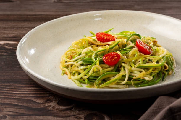 istock Zucchini spaghetti with tomatoes in garlic and oil. 1357425873