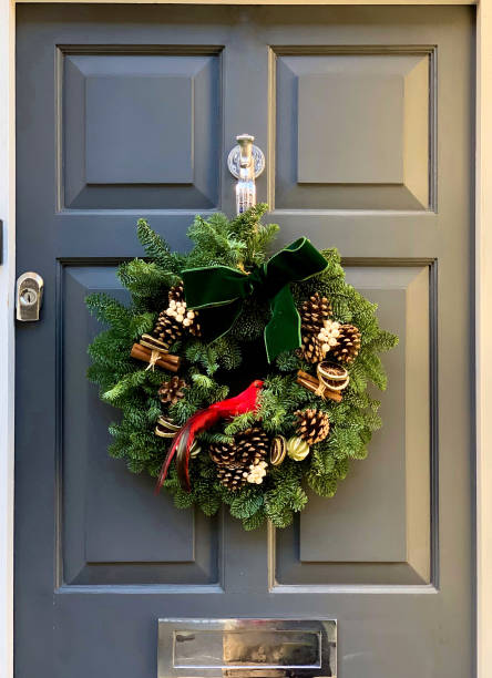 istock Christmas wreath on a grey wooden door 1357426719