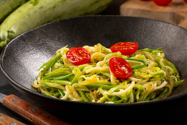 istock Zucchini spaghetti with tomatoes in garlic and oil. 1357426812