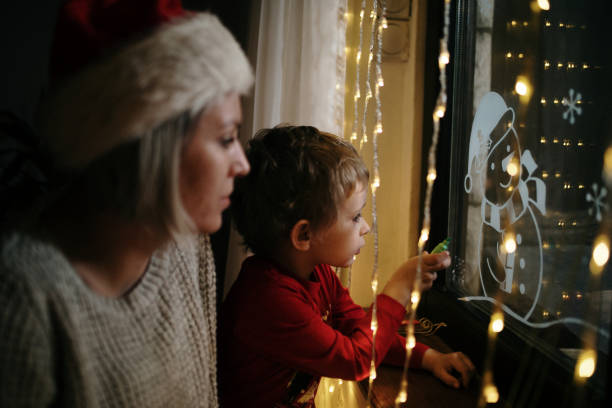istock Little boy draws on a window in the winter 1357426814