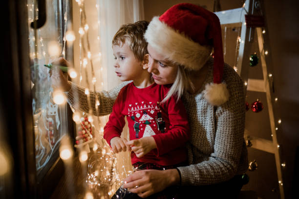 istock Little boy draws on a window in the winter 1357426996