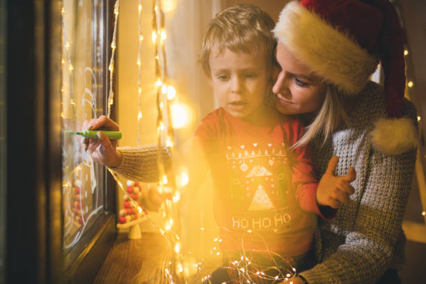 istock Little boy draws on a window in the winter 1357427045