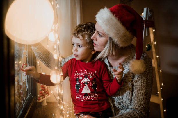 istock Little boy draws on a window in the winter 1357427144