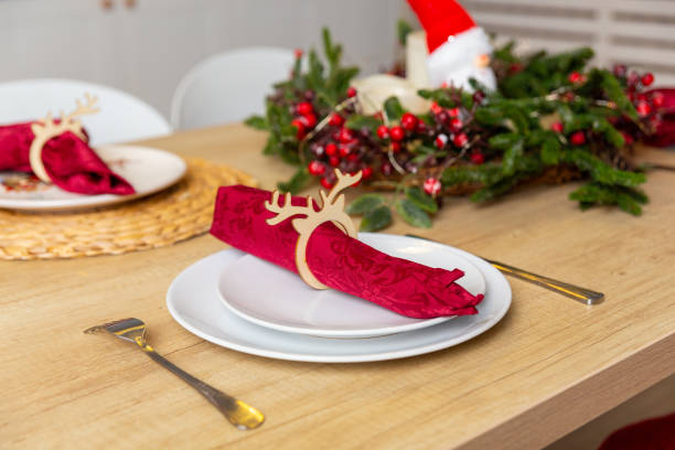 istock Beautiful table setting with Christmas decor in living room. 1357427199