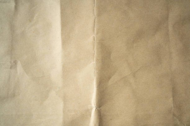 istock Crumpled Kraft paper with crease in the middle 1357429255