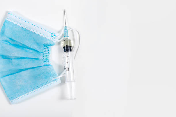 istock Injectable Medicine With Doctor's Mask And Syringe With Needle 1357432599