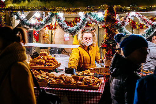 Christmas fair in Gdansk - people buying a street food  on \