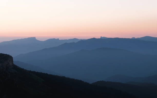 istock Mountain silhouettes layers in the sunset light 1357434334