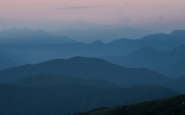 istock Mountain silhouettes layers in the sunset light 1357434344