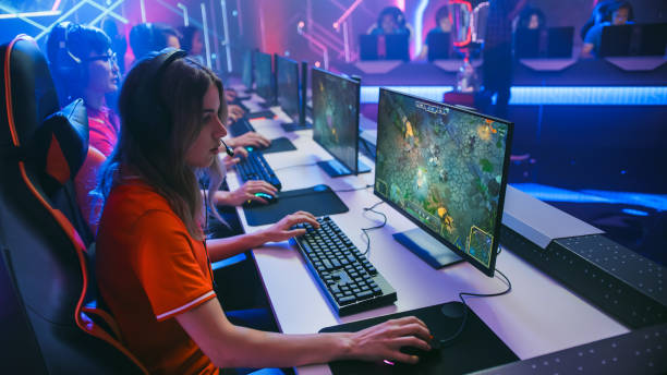 Pro Girl Plays Computer Game Plays RPG Strategy on a Championship. Diverse Esport Team of Pro Gamers Play in Mock-up Video Game. Stylish Neon Cyber Games Arena. Side View Shot Pro Girl Plays Computer Game Plays RPG Strategy on a Championship. Diverse Esport Team of Pro Gamers Play in Mock-up Video Game. Stylish Neon Cyber Games Arena. Side View Shot esports stock pictures, royalty-free photos & images