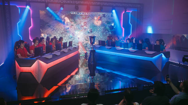 two esport teams of pro gamers play in rpg strategy video game on a championship arena with big screen showing mock-up gameplay. cyber games tournament event with competing players, spectators cheer - esport audience bildbanksfoton och bilder