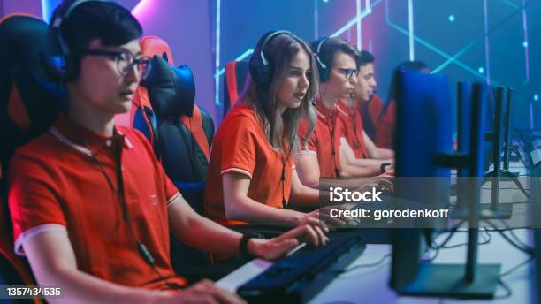 Diverse Esport Team Of Pro Gamers Play In Mockup Rpg Strategy Video Game On A Championship Stylish Neon Cyber Games Arena Online Broadcasting Of Tournament Event Side View Shot Stock Photo - Download Image Now