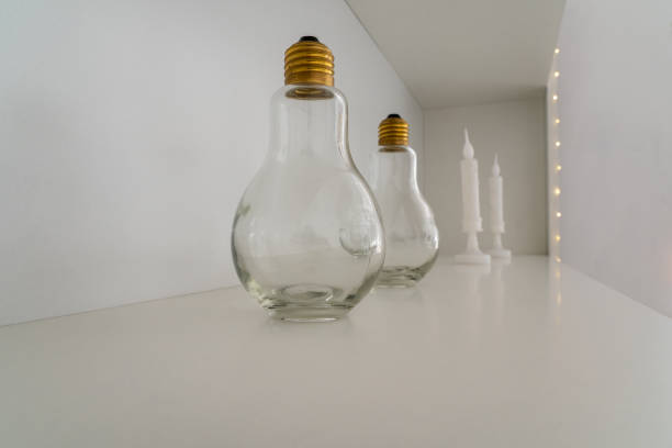 istock Photo of two transparent light bulbs on a white background with copy space for text 1357434814