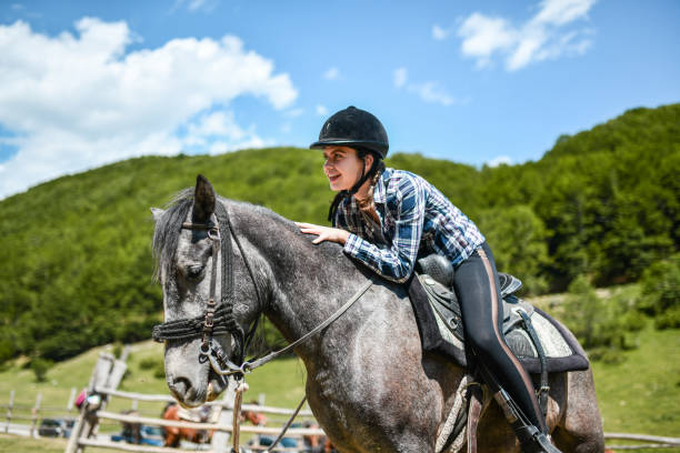 istock Female Calming Down Horse While Riding And Training It On Ranch 1357436178