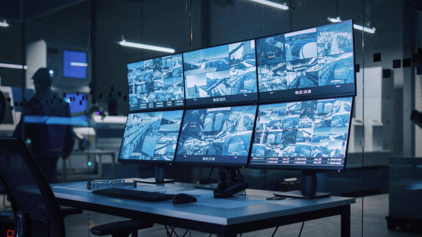 istock Industry 4.0 Modern Factory: Security Control Room with Multipoke Computer Screens Showing Surveillance Camera Footage Feed. High-Tech Security 1357436641