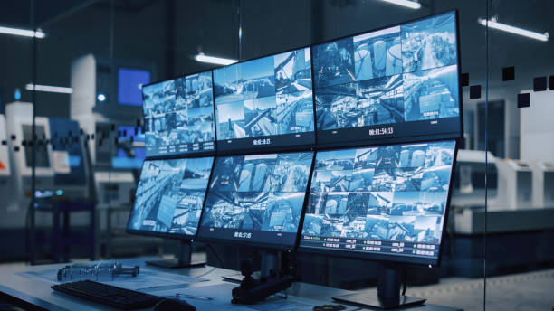 Industry 4.0 Modern Factory: Security Control Room with Multipoke Computer Screens Showing Surveillance Camera Feed. High-Tech Security Industry 4.0 Modern Factory: Security Control Room with Multipoke Computer Screens Showing Surveillance Camera Feed. High-Tech Security industrial style photos stock pictures, royalty-free photos & images