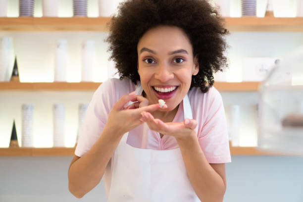 istock Happy woman working at an ice cream parlor 1357437908