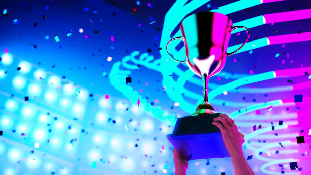 istock 3D rendering gold trophy on e-sport winner hands on backgound event stadium, win concept. 1357441440