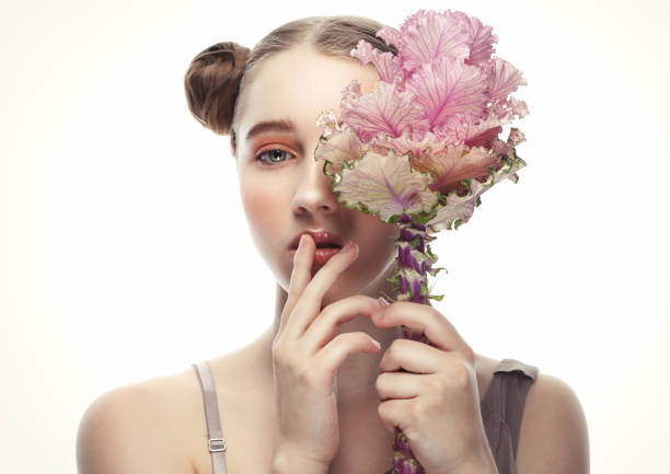 beauty and fashion concept: teenager female model with perfect make up and pink flowers