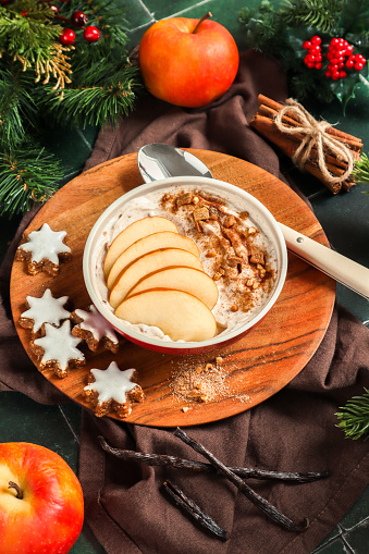 Porridge bowl with baked apple dessert with cinnamon and nuts