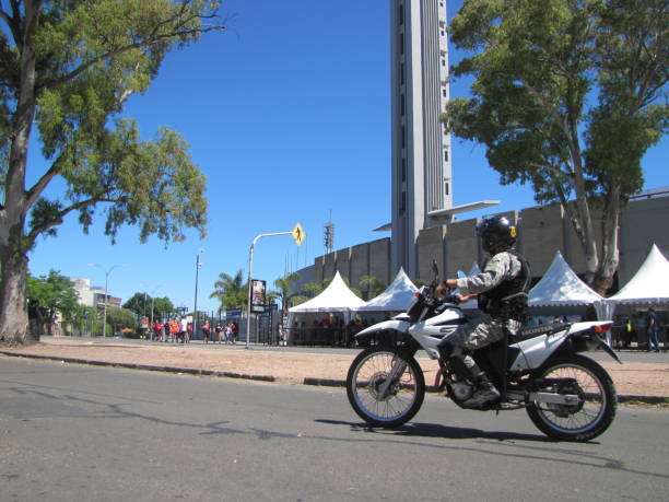 Centenario Stadium Final soccer Copa Conmebol Sudamericana 2021 Atletico Paranaense vs Bragantino. Police guard the entrance to the soccer field. The historic concrete stadium built in 1930 with modern architecture is the place where Brazilian football teams play the final in Montevideo Uruguay. Security is protected by the police. Clear sunny day in the stadium. Fans, Police, security. Montevideo, Uruguay. south american football confederation stock pictures, royalty-free photos & images