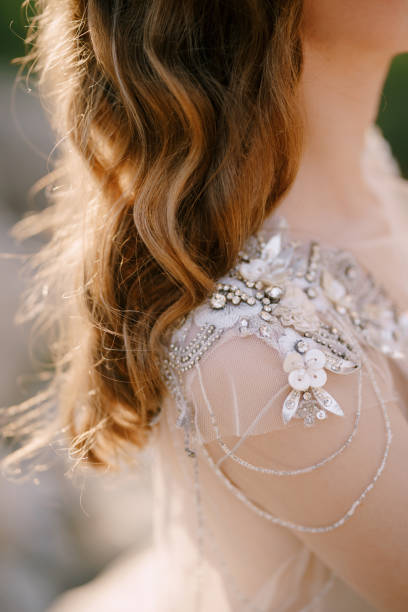 istock Bride shoulder in a sequin and beaded tulle dress. Close-up 1357448916