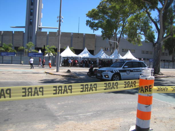 Centenario Stadium Final soccer Copa Conmebol Sudamericana 2021 Atletico Paranaense vs Bragantino. Police guard the entrance to the soccer field. The historic concrete stadium built in 1930 with modern architecture is the place where Brazilian football teams play the final in Montevideo Uruguay. Security is protected by the police. Clear sunny day in the stadium. Fans, Police, security. Montevideo, Uruguay. south american football confederation stock pictures, royalty-free photos & images