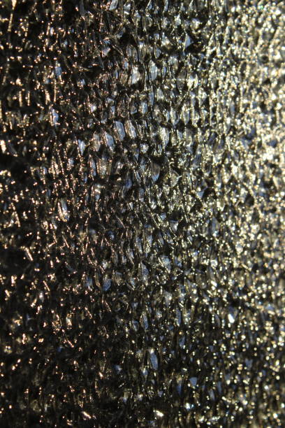 istock Photograph close-up of glass embossed surface with refractive light uneven bumpy texture background 1357450215