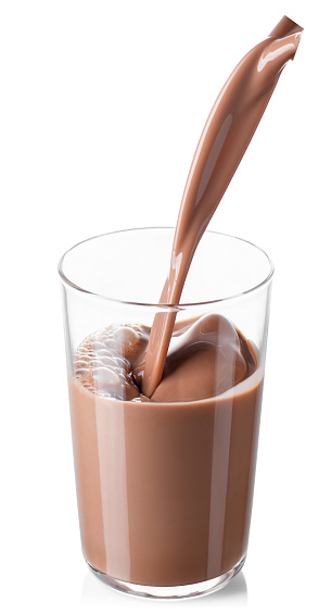 chocolate milk or cocoa drink pouring into glass isolated on white background