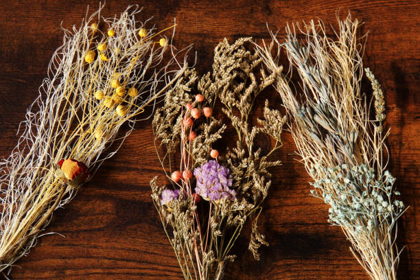 istock Wooden background and dried flowers. 1357453663