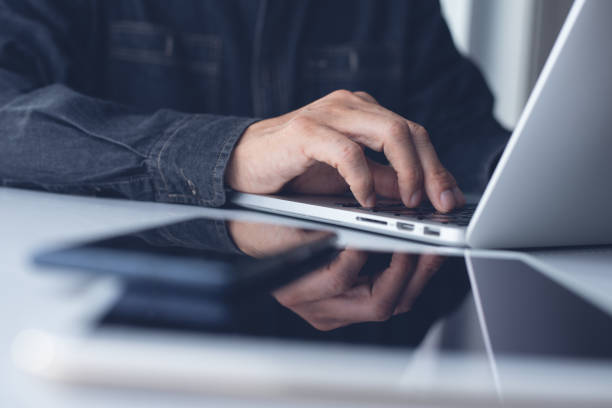 istock Business man working on laptop in modern office 1357455765