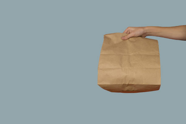 istock Paper bag in hand. Home delivery concept. 1357455814