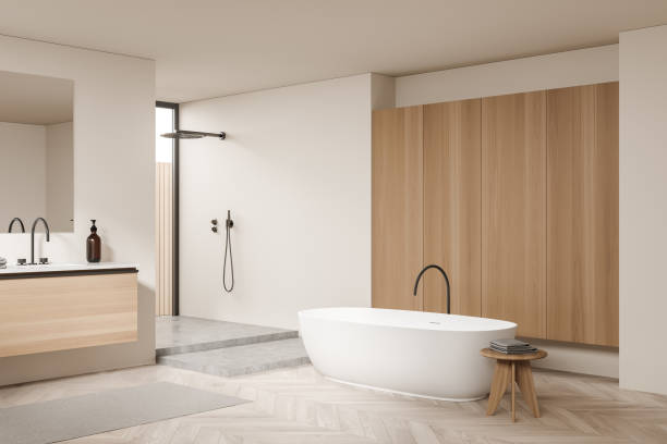 istock Light bathroom interior with sink and mirror, tub and douche 1357456253