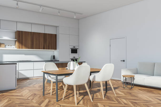 istock White kitchen set interior with dining table and four seats, sofa near door 1357456273