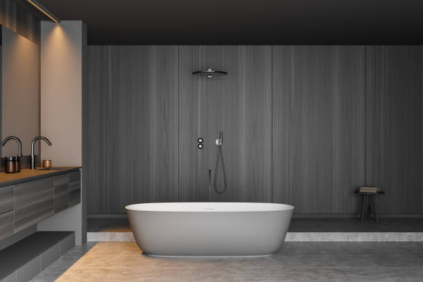istock Grey wood look bathroom with oval ceramic bathtub 1357457413
