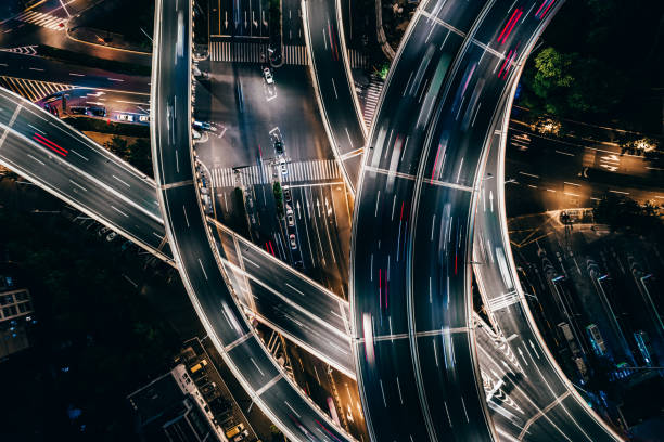 drone point view of overpass and city traffic at night - street light street bridge illuminated imagens e fotografias de stock