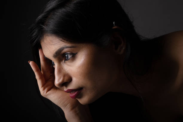 Low key portrait of young female model with  moody expression