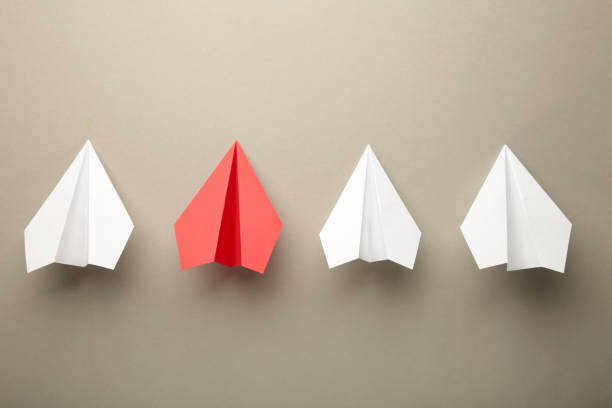 istock White and red paper planes on grey background, Business competition concept. 1357460074