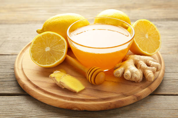 istock Ginger tea with lemon and honey on cutting board on grey wooden background. 1357460148