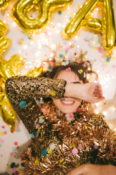 Photo of a young woman lying down on the floor after the New Year's Eve party