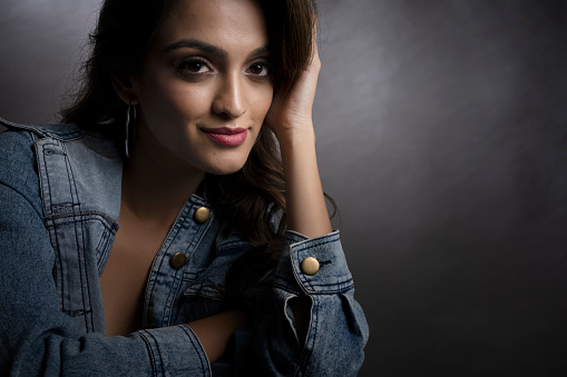 Young Indian female model wearing denim wear and maroon crop top