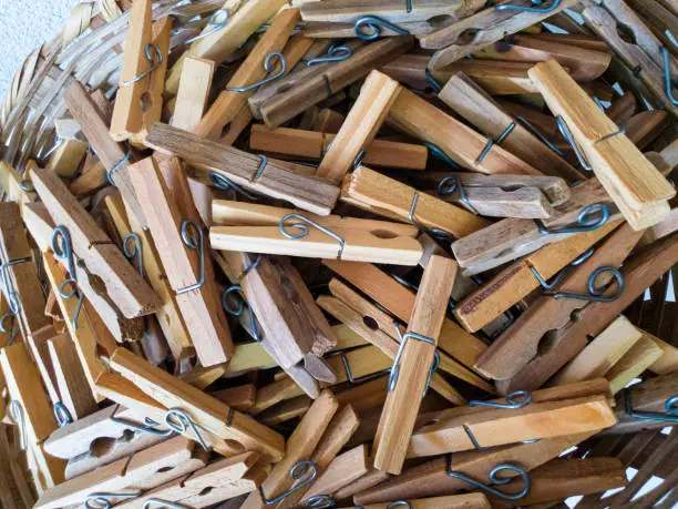 Photo of many wooden clothespins.