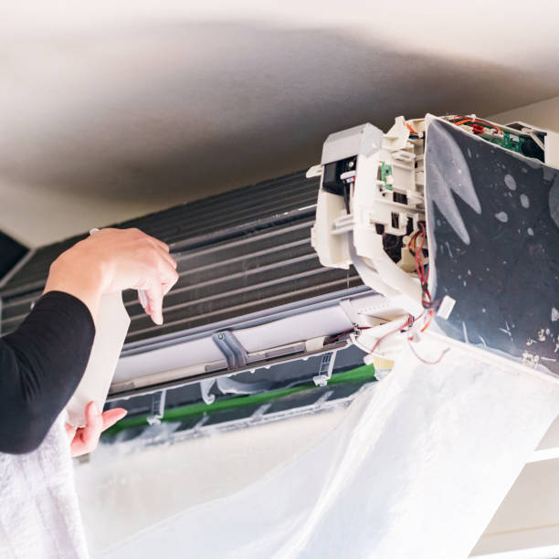 istock Cleaning Air conditioner in living room 1357466341