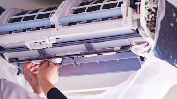 istock Cleaning Air conditioner in living room 1357466419