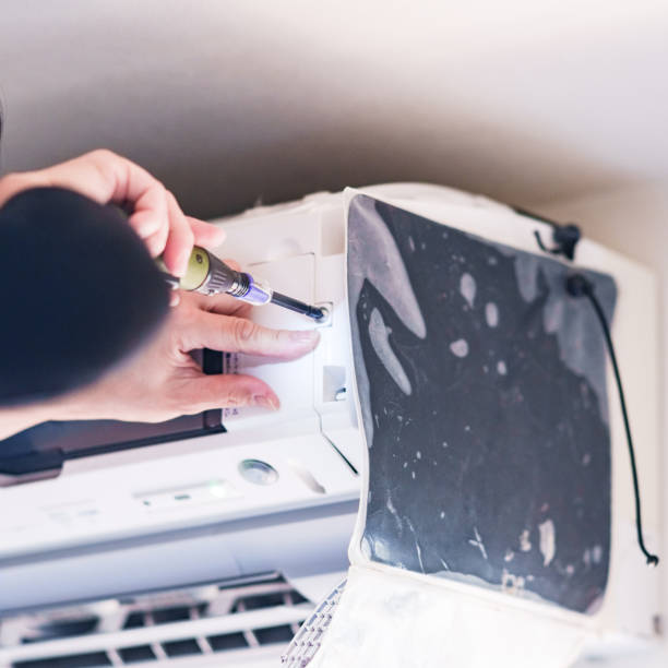 istock Cleaning Air conditioner in living room 1357466457