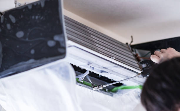 istock Cleaning Air conditioner in living room 1357466491
