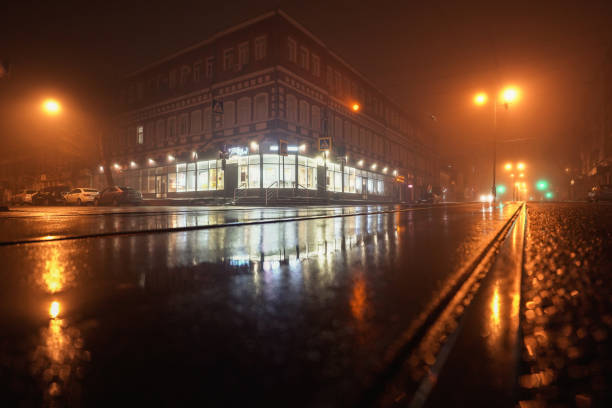 istock Foggy Night Street Tram Rails & Storefront 1357469514