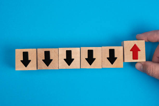 istock Alternative business development concept - hand holds wooden cube with red arrow. 1357469803