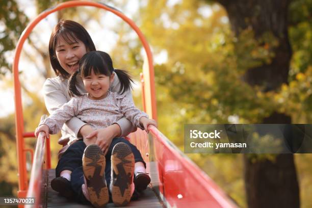 Parents And Children Playing On The Slide Stock Photo - Download Image Now - Child, Playing, Offspring