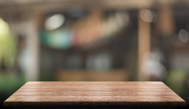 istock Empty wooden table top with lights bokeh on blur restaurant background 1357471044